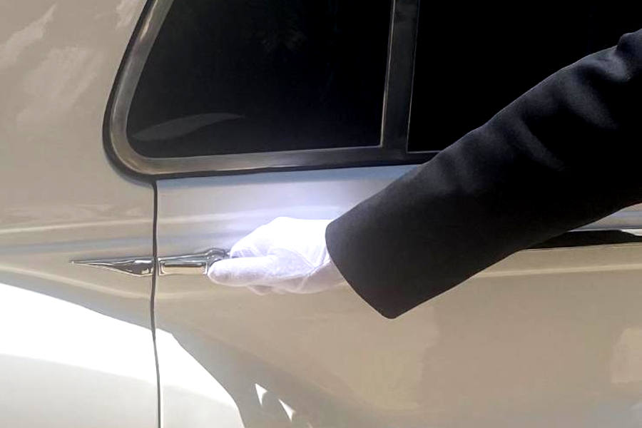 limo driver opening door with gloved hand